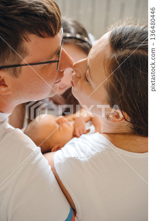 Family shares moments with baby in a cozy space 136480446