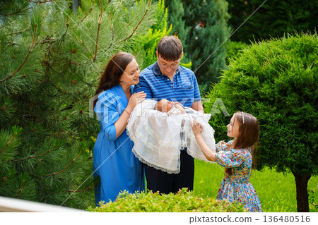 Family gathers for baby presentation in garden Family gathers for baby presentation in garden 136480516
