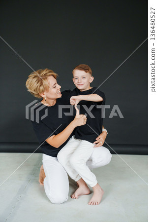 Mother and son share a moment of fun indoors during their photoshoot Mother and son share a moment of fun indoors during their photoshoot 136480527