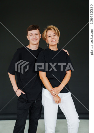 Portrait of a young man and a woman in black and white outfits Portrait of a young man and a woman in black and white outfits 136480589