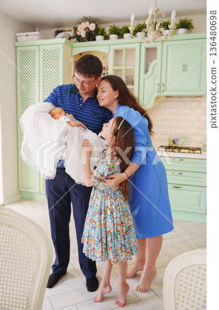 Family gathers to welcome new baby in cheerful kitchen Family gathers to welcome new baby in cheerful kitchen 136480698