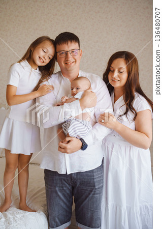 Family together in cozy setting with baby Family together in cozy setting with baby 136480707