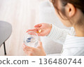 A young woman who takes medicine 136480744