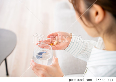 A young woman who takes medicine A young woman who takes medicine 136480744