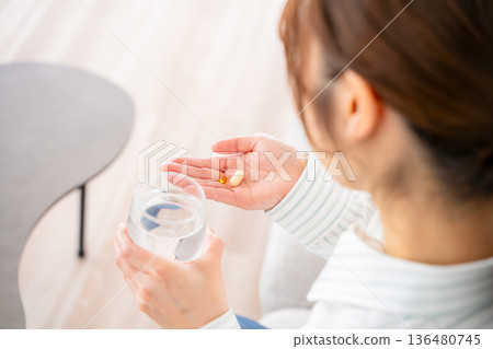 A young woman who takes medicine A young woman who takes medicine 136480745