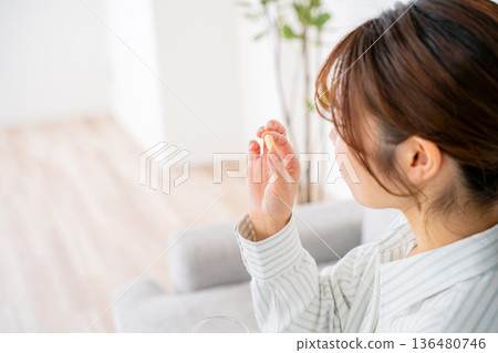 A young woman who takes medicine A young woman who takes medicine 136480746