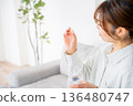 A young woman who takes medicine 136480747