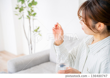 A young woman who takes medicine A young woman who takes medicine 136480747