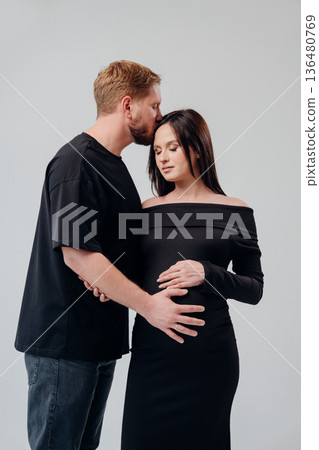 Couple sharing a tender moment during pregnancy celebration Couple sharing a tender moment during pregnancy celebration 136480769