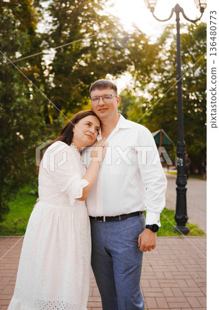Couple enjoying a sunny day in a green park 136480773