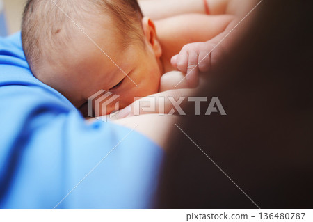 Mother and newborn share feeding moment in hospital Mother and newborn share feeding moment in hospital 136480787