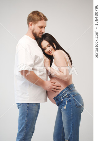 Couple celebrates pregnancy with intimate moment together Couple celebrates pregnancy with intimate moment together 136480796
