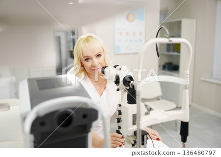 Ophthalmologist examining a patient in a clinic setting 136480797