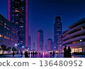 Strolling Through Futuristic Cityscape Illuminated by Vibrant Neon Lights at Night 136480952