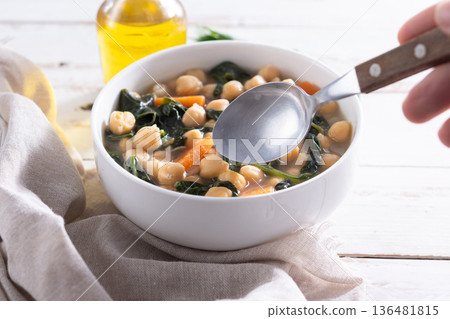 Chickpea and Spinach Soup with Carrots in White Bowl Chickpea and Spinach Soup with Carrots in White Bowl 136481815