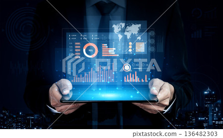 Businessman in Suit Holding Digital Tablet with Graphs, Charts and World Map Displaying Financial Data Against a Night City Skyline Background Scalp Businessman in Suit Holding Digital Tablet with Graphs, Charts and World Map Displaying Financial Data Against a Night City Skyline Background Scalp 136482303