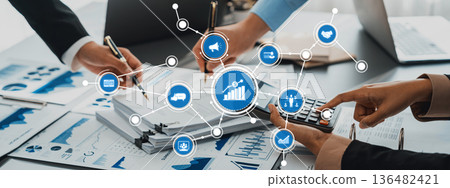 Hands of Business Professionals Analyzing Data and Statistics with Calculator and Graphs in a Modern Office Environment. Amity Hands of Business Professionals Analyzing Data and Statistics with Calculator and Graphs in a Modern Office Environment. Amity 136482421