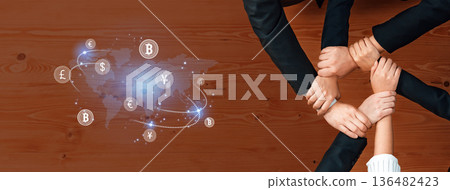 Diverse Hands Collaborating Over Financial Technology and Cryptocurrency Concept with Global Currency Symbols and Digital Interface on Wooden Table Trope Diverse Hands Collaborating Over Financial Technology and Cryptocurrency Concept with Global Currency Symbols and Digital Interface on Wooden Table Trope 136482423