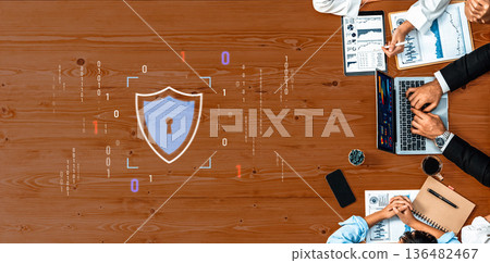 Professional meeting focused on cybersecurity strategies with digital shield graphic representing data protection and secure information management practices Trope 136482467