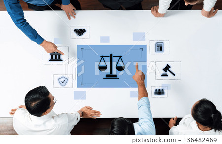 Team Collaboration Around Digital Justice Concept with Scales of Justice on Touchscreen Display in Office Environment Trope Team Collaboration Around Digital Justice Concept with Scales of Justice on Touchscreen Display in Office Environment Trope 136482469