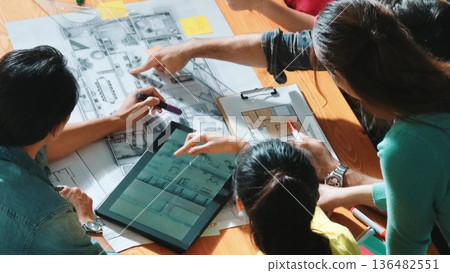 Top view of engineer team writing at blueprint and planning design. Symposium. 136482551