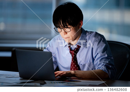 Businessman feeling tired after working overtime 136482608