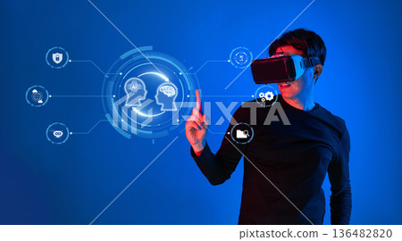 A Person Using Virtual Reality Headset Engaging with AI-Driven Icons in Futuristic Digital Environment XDMCP A Person Using Virtual Reality Headset Engaging with AI-Driven Icons in Futuristic Digital Environment XDMCP 136482820