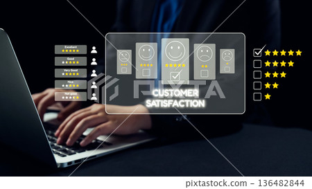 Business Professional Evaluating Customer Satisfaction Through Feedback Forms and Star Ratings on Laptop in Modern Office Setting. Qubit Business Professional Evaluating Customer Satisfaction Through Feedback Forms and Star Ratings on Laptop in Modern Office Setting. Qubit 136482844