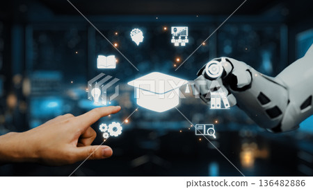 Human Hand Interacting with Robotic Arm Displaying Educational Icons Against a Futuristic Background in Technology and Learning Concept. Auvana Human Hand Interacting with Robotic Arm Displaying Educational Icons Against a Futuristic Background in Technology and Learning Concept. Auvana 136482886