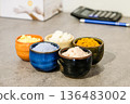 Colorful natural cosmetic ingredients in small ceramic bowls on a table. 136483002