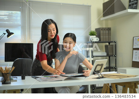 A colleague team in a creative brainstorming session on design colour and analyzing colorful charts and drafts 136483534