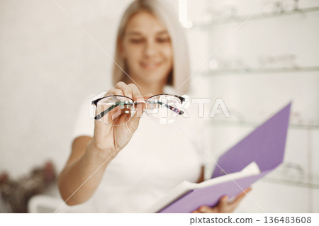 Girl in the store. Woman in a white t-shirt. Girl in the store. Woman in a white t-shirt. 136483608