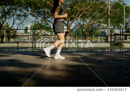 Closeup woman running in the park Closeup woman running in the park 136483617