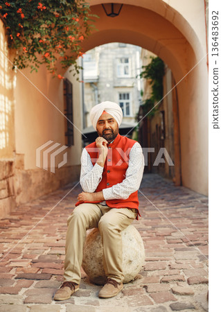 Indian man in a city. Male in a traditional turban. Hinduist in a summer city. 136483692