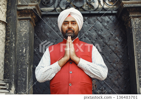 Indian man in a city. Male in a traditional turban. Hinduist in a summer city. 136483701