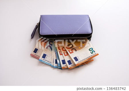 Close-up of euro bills inside a leather wallet. Security and modern financial tools. Close-up of euro bills inside a leather wallet. Security and modern financial tools. 136483742
