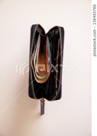 A wallet filled with euro banknotes on a table. Spending power and financial confidence. A wallet filled with euro banknotes on a table. Spending power and financial confidence. 136483766