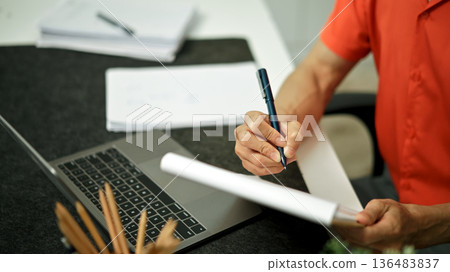 Document with a man checking searching document legal prepare paperwork or report for analysis 136483837