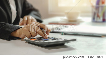 businessman using calculator for working with documents businessman using calculator for working with documents 136483871