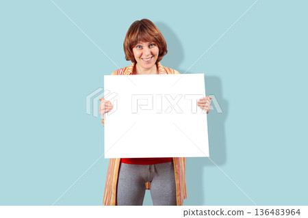 Smiling woman holding blank white sign board Smiling woman holding blank white sign board 136483964