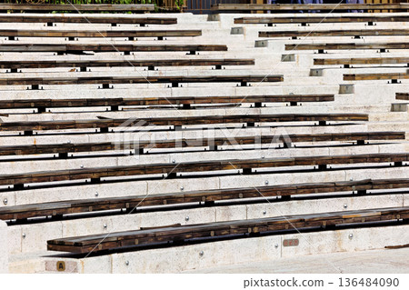 Weathered Wooden Benches on Tiered Concrete Steps Background 136484090