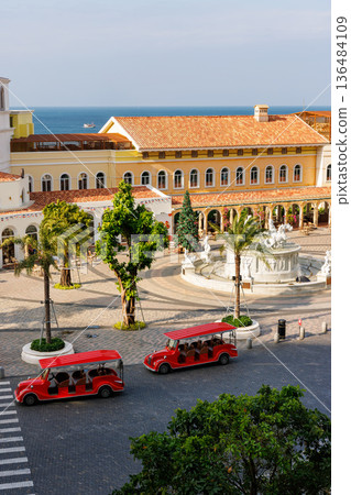 Red Tourist Cars and King of the Sun Fountain at Sunrise Plaza 136484109