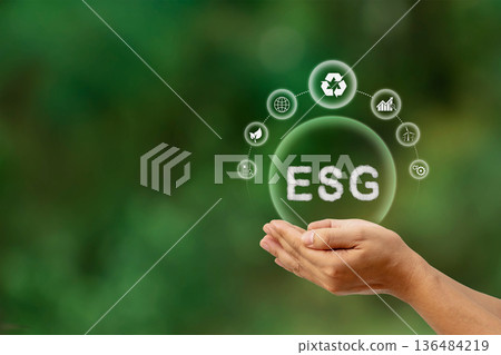 The ESG symbol in hand represents Environment, Society, and Governance, in the principles of sustainable business development. The ESG symbol in hand represents Environment, Society, and Governance, in the principles of sustainable business development. 136484219