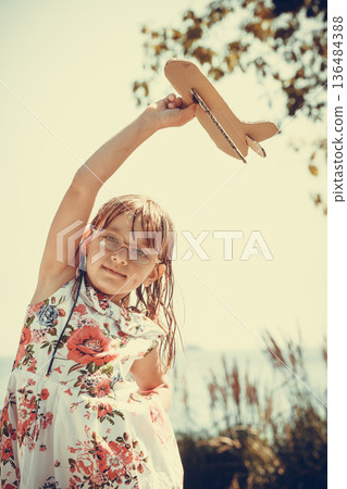 Little girl kid outdoor with paper plane airplane. Little girl kid outdoor with paper plane airplane. 136484388