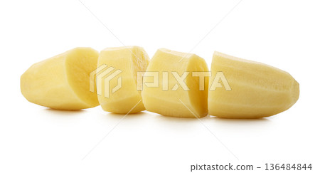Raw potatoes cut into pieces isolated on a white background Raw potatoes cut into pieces isolated on a white background 136484844