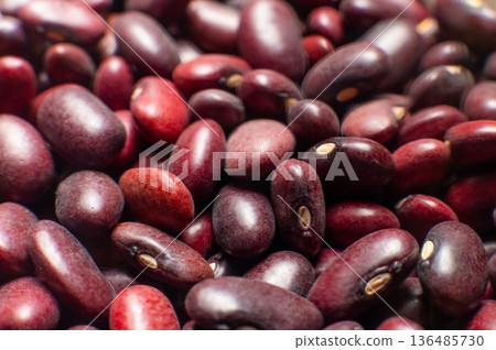 A close-up of a large amount of red kidney beans in a clear storage jar. Macro shot of the beans with a shallow depth of field. 136485730