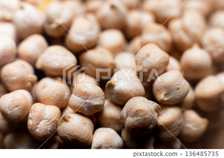 Close-up macro of raw chickpea kernels in a clear storage jar Close-up macro of raw chickpea kernels in a clear storage jar 136485735