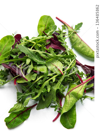 Fresh mixed salad greens creating healthy vegan food 136485862