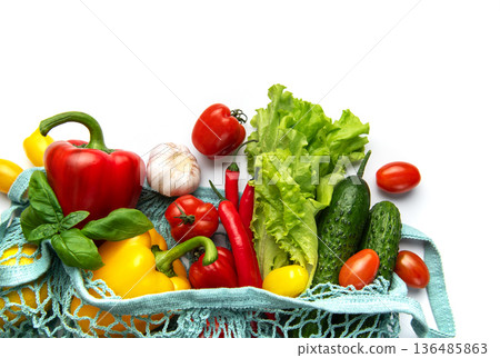 Fresh organic vegetables in reusable shopping bag on white Fresh organic vegetables in reusable shopping bag on white 136485863