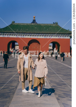 lovely couple exploring tourist attractions in Beijing China. Couple exploring temple of heaven in Beijing China. Couple experiencing chinese culture and architecture. 136486044